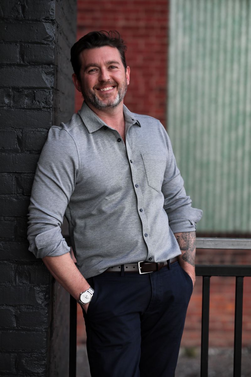 Eric Otto against a black brick wall