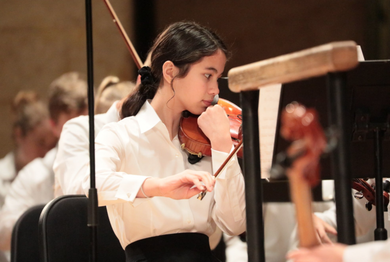 student playing violin in class